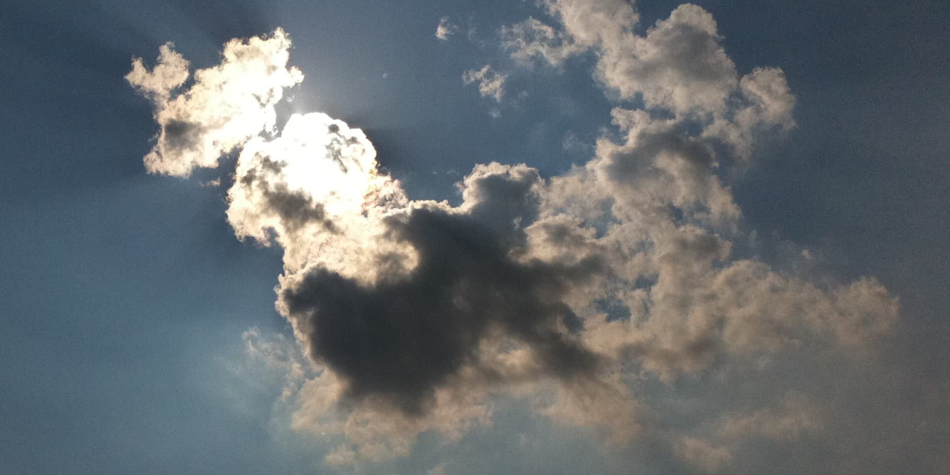 Dark clouds rolling in, with the sun just breaking through